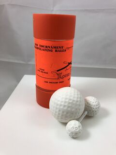 Fakini.Diminishing Golf ball with package tube.1.jpeg